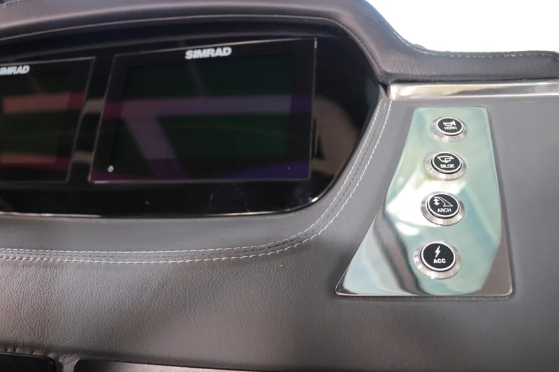 Slide: The Image of Dashboard of 2026 Chaparral 250 OSX with Simrad displays and control buttons. - 35