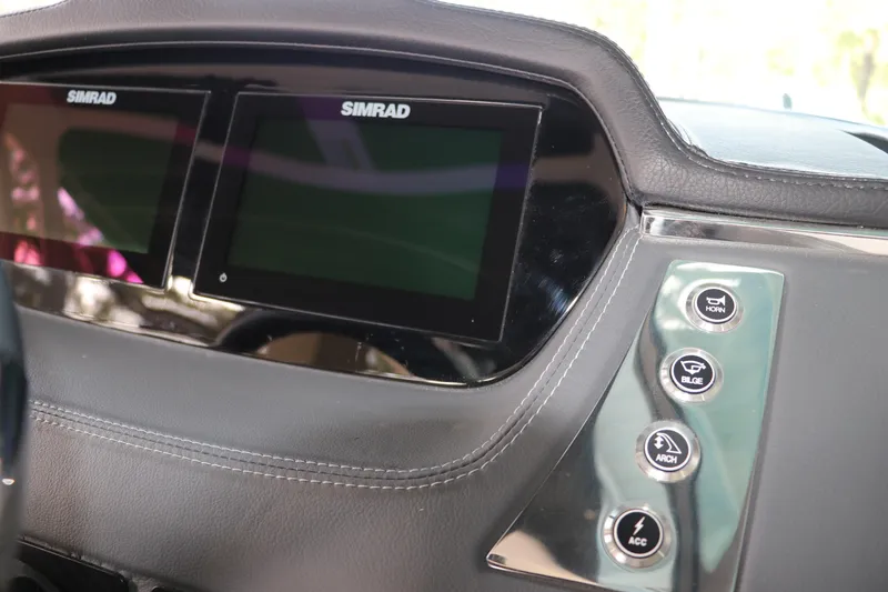 Slide: The Image of Dashboard of 2026 Chaparral 250 OSX with Simrad displays and control buttons. - 36