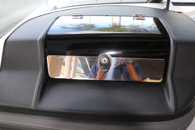 Slide: The Image of Dashboard of 2026 Chaparral 250 OSX boat with reflective panel and lock. - 45