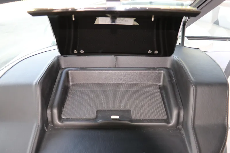 Slide: The Image of Open storage compartment in 2026 Chaparral 250 OSX boat dashboard. - 46