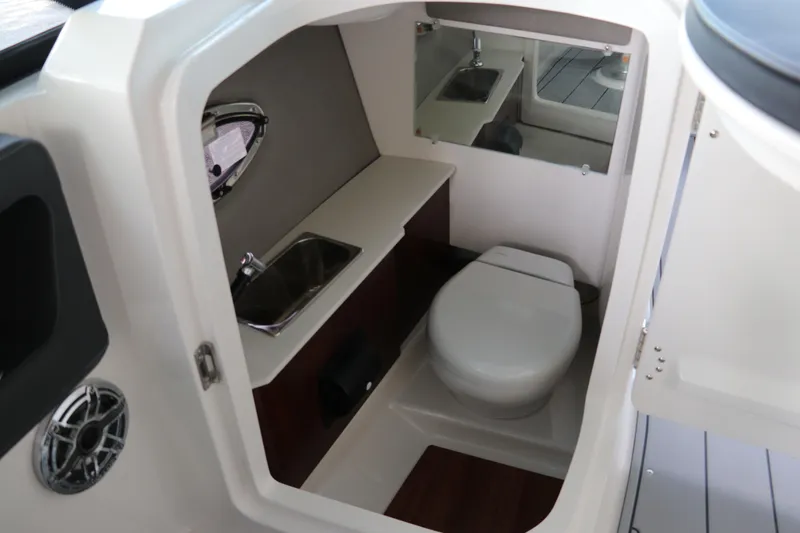 Slide: The Image of 2026 Chaparral 250 OSX boat interior bathroom with sink and toilet. - 47