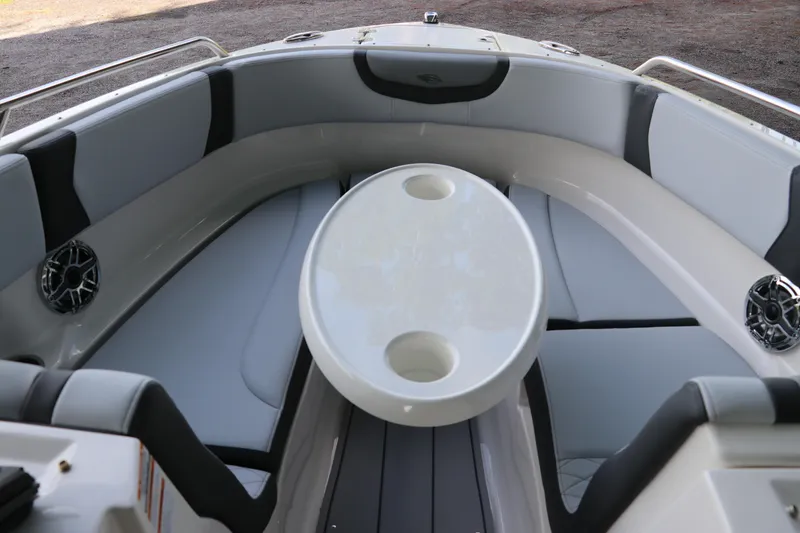 Slide: The Image of 2026 Chaparral 250 OSX boat interior with cushioned seating and oval table. - 51