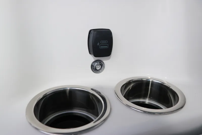 Slide: The Image of Cup holders and control panel on 2026 Chaparral 250 OSX boat interior. - 55