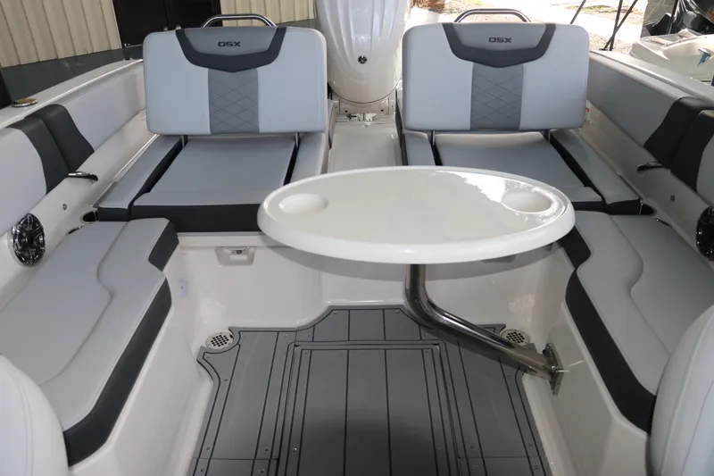 Slide: The Image of 2026 Chaparral 250 OSX boat interior with seating and round table. - 60