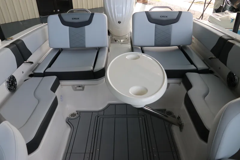Slide: The Image of 2026 Chaparral 250 OSX boat interior with gray seating and round table. - 61