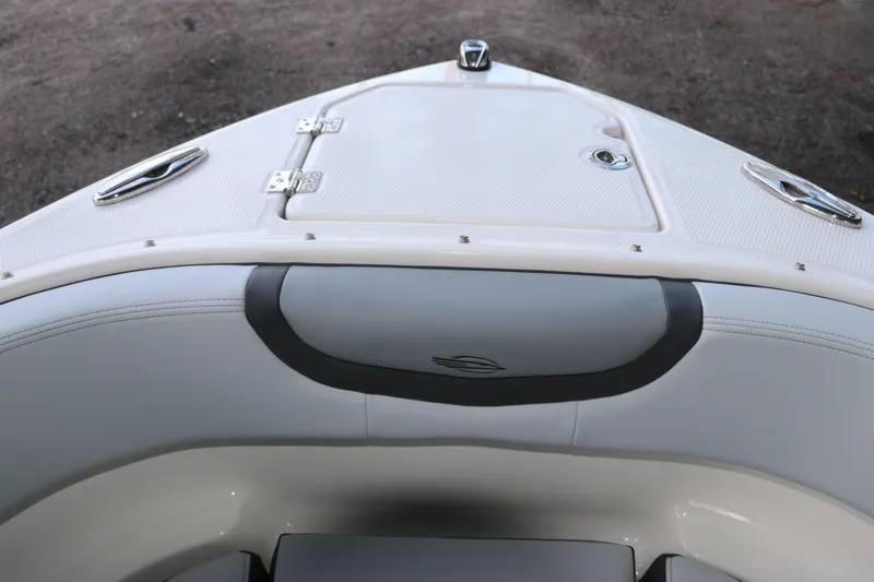 Slide: The Image of 2026 Chaparral 250 OSX boat bow with sleek seating and storage compartment. - 64