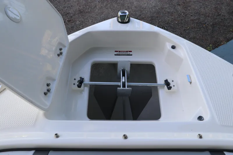 Slide: The Image of 2026 Chaparral 250 OSX boat anchor compartment with open hatch. - 65