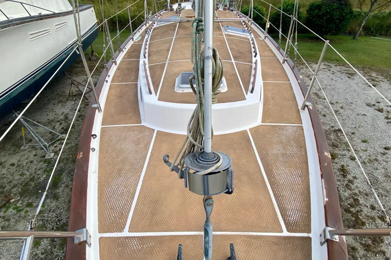 Slide: The Image of 1983 Liberty 38 Cutter sailboat deck with rigging, on land for maintenance. - 10
