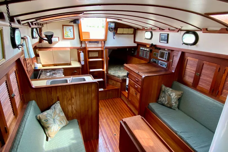 Slide: The Image of Interior of 1983 Liberty 38 Cutter sailboat with wooden furnishings and cozy seating. - 20
