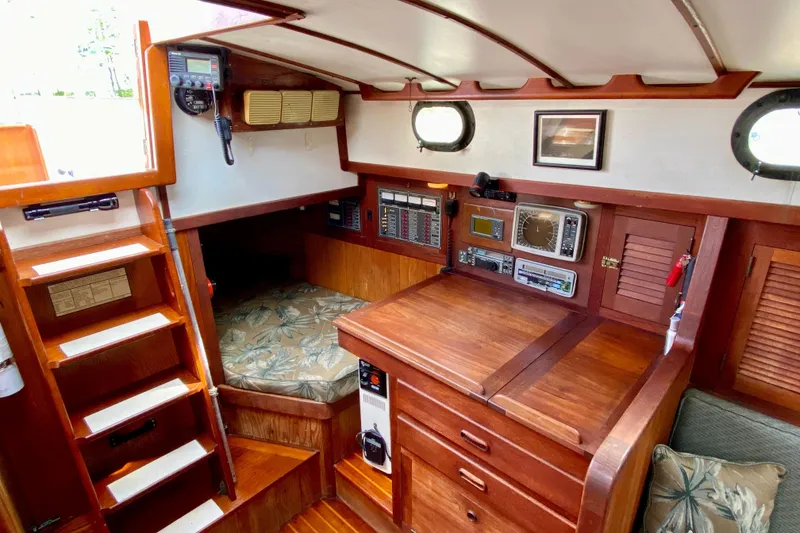 Slide: The Image of Interior of 1983 Liberty 38 Cutter sailboat with navigation equipment and wooden cabinetry. - 21