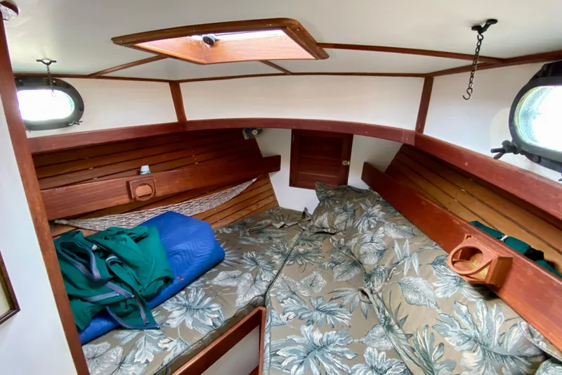 Slide: The Image of Cozy cabin interior of 1983 Liberty 38 Cutter sailboat with floral bedding and wooden accents. - 22