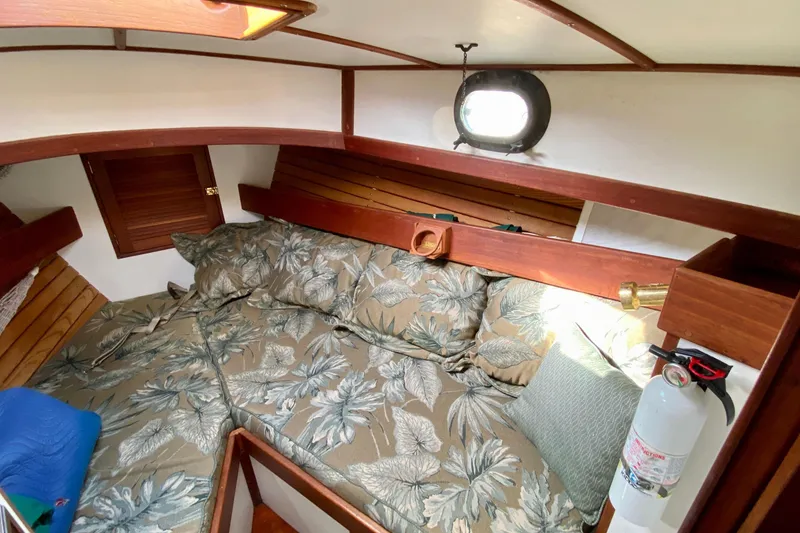 Slide: The Image of Cozy cabin interior of 1983 Liberty 38 Cutter sailboat with floral bedding and wooden accents. - 23