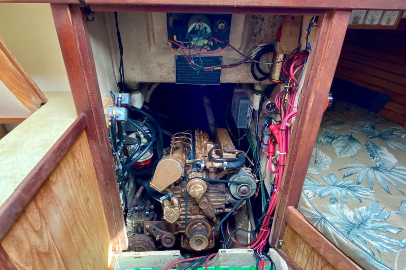 Slide: The Image of Engine compartment of 1983 Liberty 38 Cutter sailboat, showing detailed mechanical components. - 26