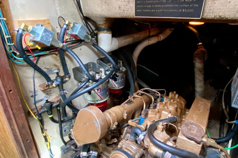 Slide: The Image of Engine room of 1983 Liberty 38 Cutter with visible wiring and mechanical components. - 28