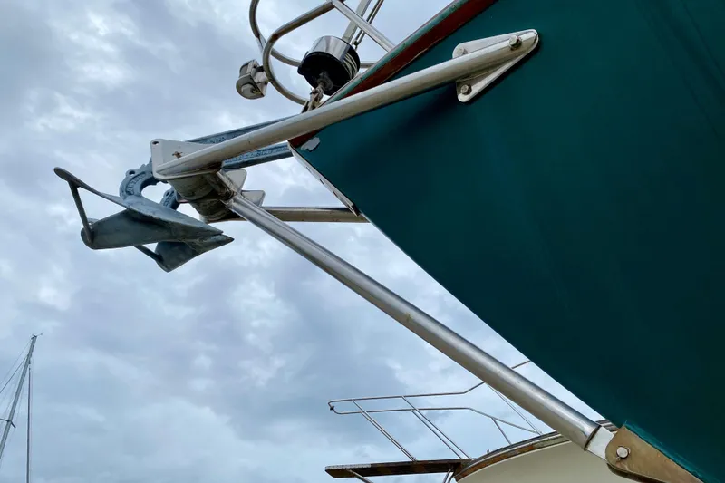 Slide: The Image of Anchor and bow of 1983 Liberty 38 Cutter against cloudy sky. - 34