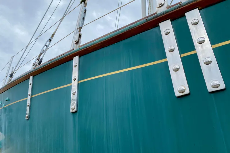 Slide: The Image of Close-up of 1983 Liberty 38 Cutter sailboat hull with metal fittings. - 36