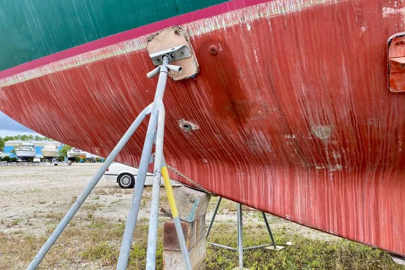 Slide: The Image of Close-up of 1983 Liberty 38 Cutter hull on stands in a boatyard. - 39