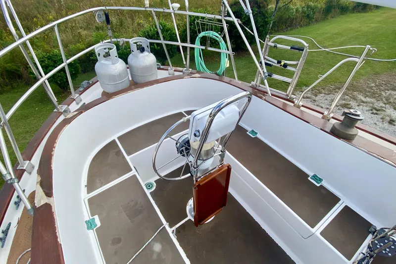 Slide: The Image of Cockpit of 1983 Liberty 38 Cutter sailboat with steering wheel and propane tanks. - 4