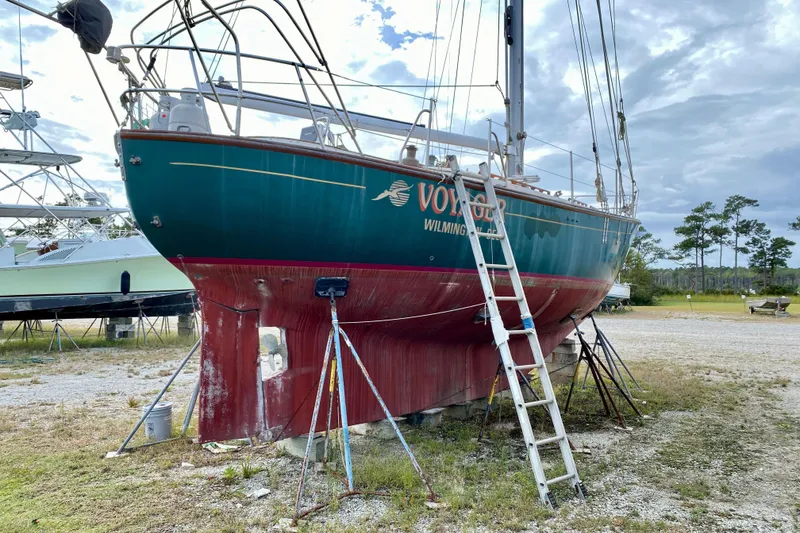 Slide: The Image of 1983 Liberty 38 Cutter sailboat on land with ladder and supports. - 45