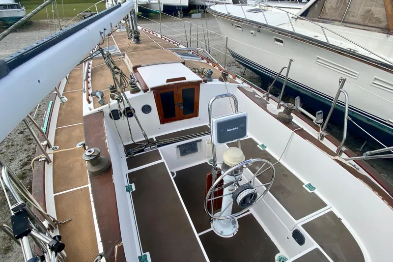 Slide: The Image of 1983 Liberty 38 Cutter sailboat cockpit with steering wheel and navigation equipment. - 5