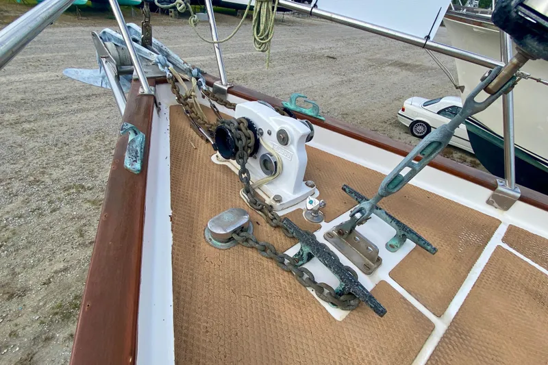 Slide: The Image of Anchor chain and windlass on 1983 Liberty 38 Cutter sailboat deck. - 9