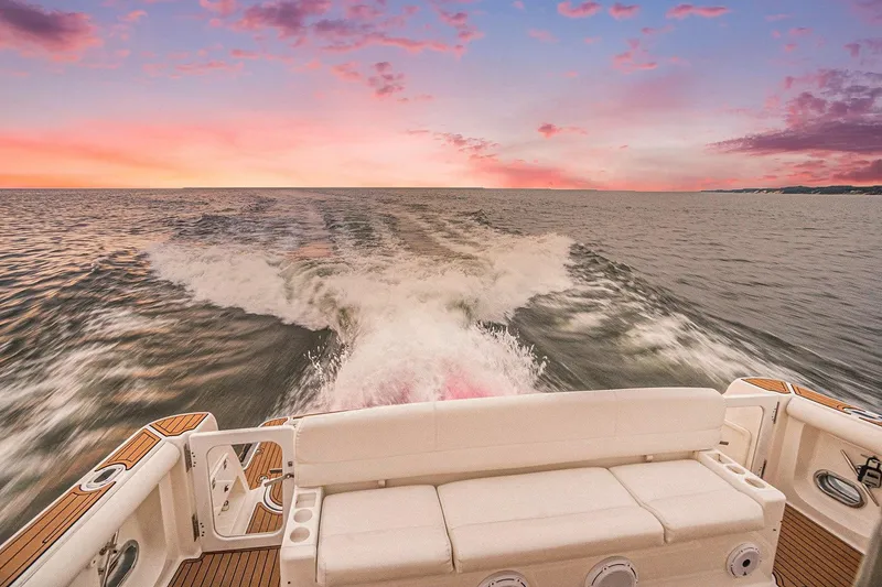 Slide: The Image of Tiara Yachts 5200 Sovran 2003 cruising at sunset, leaving a wake on the ocean. - 11