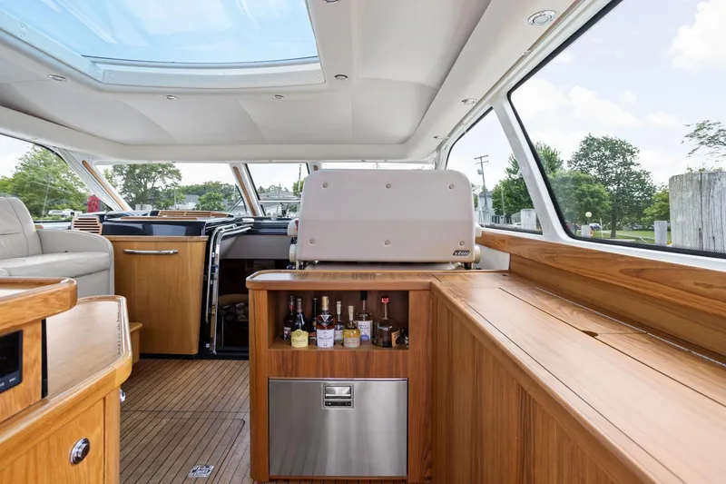 Slide: The Image of Luxurious interior of 2003 Tiara Yachts 5200 Sovran with wooden cabinetry and skylight. - 12