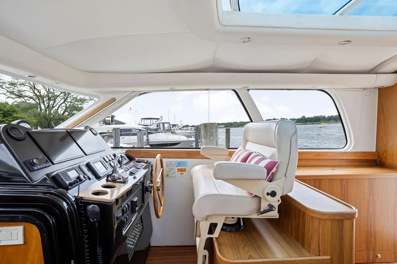 Slide: The Image of Interior view of 2003 Tiara Yachts 5200 Sovran helm with luxurious seating and control panel. - 13