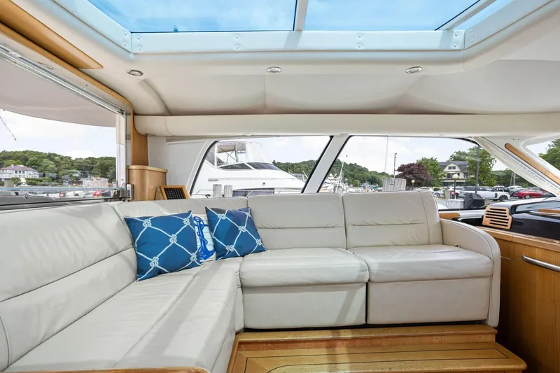 Slide: The Image of Luxurious interior of 2003 Tiara Yachts 5200 Sovran with plush seating and scenic marina view. - 19