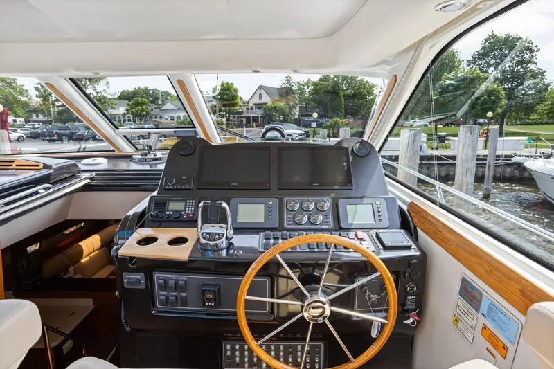 Slide: The Image of Helm of 2003 Tiara Yachts 5200 Sovran with steering wheel and navigation equipment. - 2