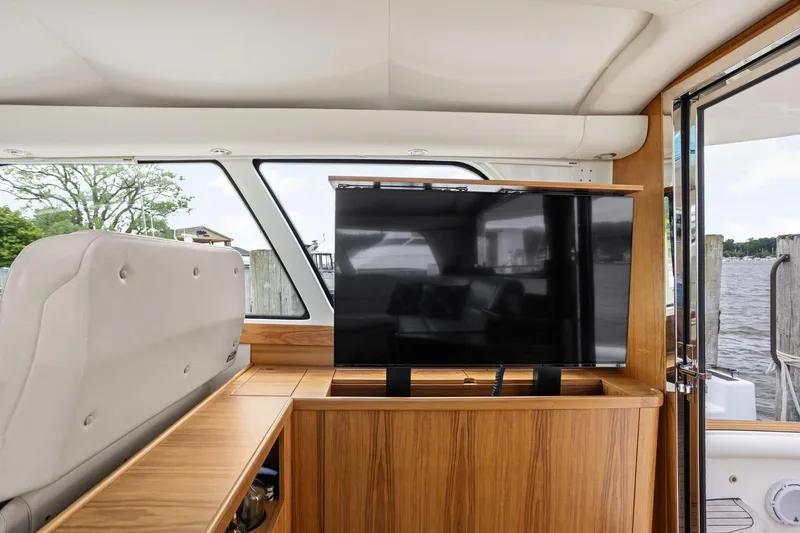 Slide: The Image of Interior of 2003 Tiara Yachts 5200 Sovran with TV and wooden cabinetry. - 22
