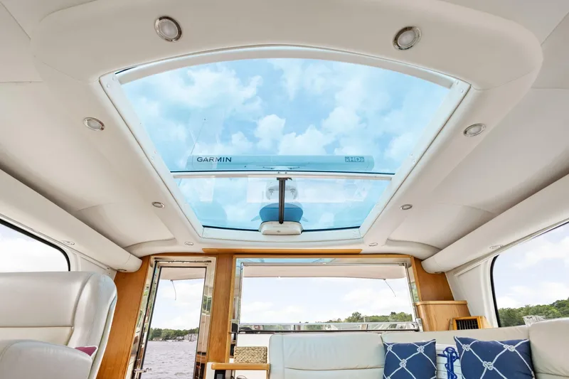 Slide: The Image of Interior view of 2003 Tiara Yachts 5200 Sovran with glass ceiling and plush seating. - 23