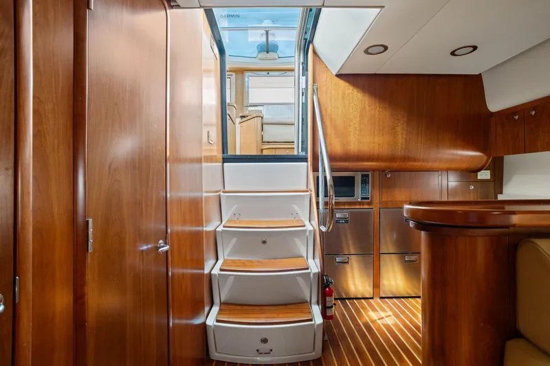 Slide: The Image of Interior of 2003 Tiara Yachts 5200 Sovran with wooden cabinetry and stairs. - 31