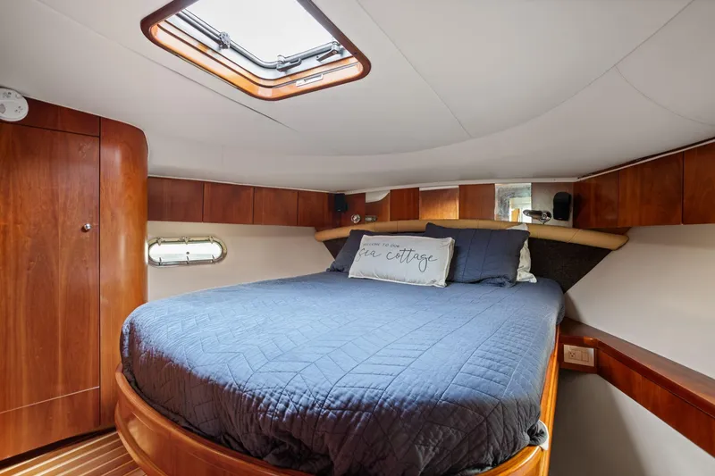 Slide: The Image of Luxurious cabin interior of 2003 Tiara Yachts 5200 Sovran with cozy bedding. - 33