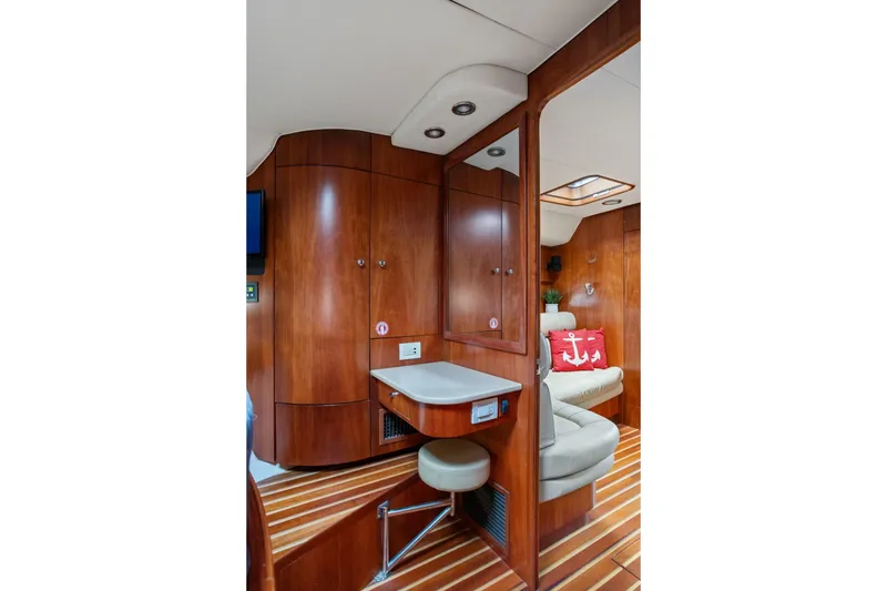 Slide: The Image of Luxurious 2003 Tiara Yachts 5200 Sovran interior with wood paneling and cozy seating. - 36