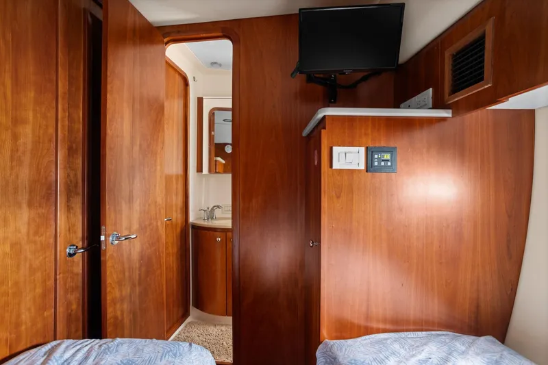 Slide: The Image of 2003 Tiara Yachts 5200 Sovran cabin interior with wood paneling and bathroom view. - 38