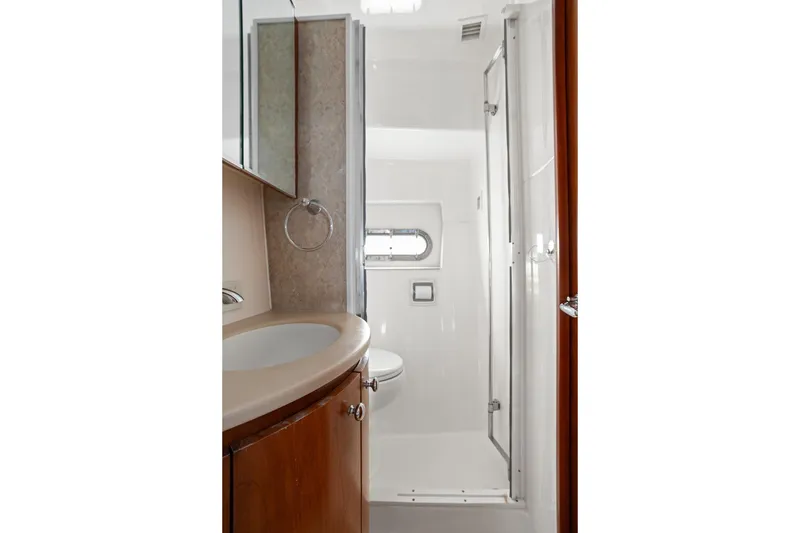 Slide: The Image of Luxurious bathroom in 2003 Tiara Yachts 5200 Sovran, featuring modern fixtures and elegant design. - 39