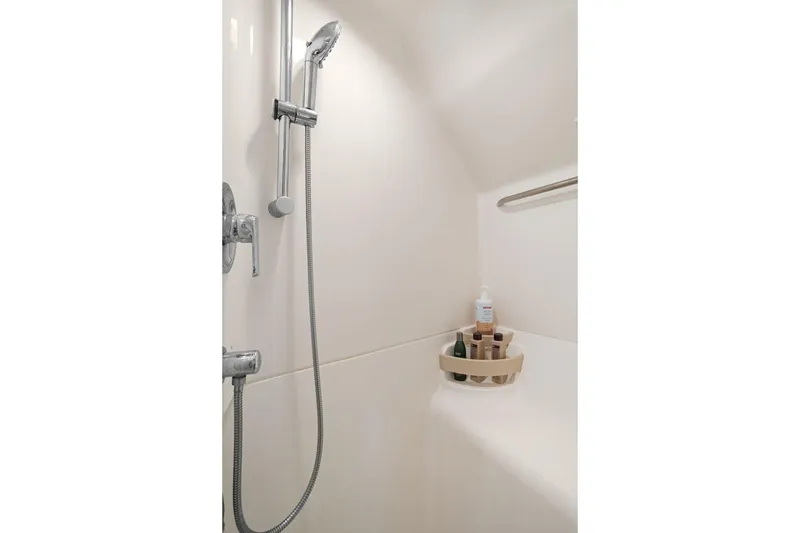 Slide: The Image of Shower area in 2003 Tiara Yachts 5200 Sovran, featuring modern fixtures and toiletries. - 42