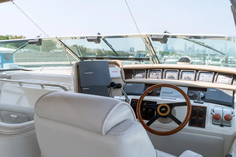 Slide: The Image of Interior view of 1996 Sea Ray 630 Super Sun Sport yacht cockpit with steering wheel and controls. - 11