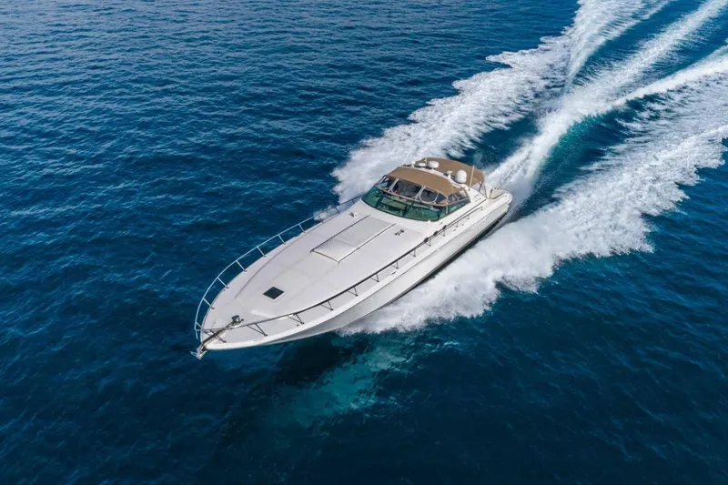 Slide: The Image of 1996 Sea Ray 630 Super Sun Sport yacht cruising on open blue water. - 2