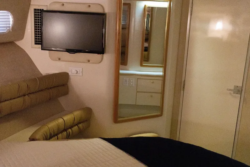 Slide: The Image of Luxurious interior of 1996 Sea Ray 630 Super Sun Sport yacht with TV and mirror. - 23