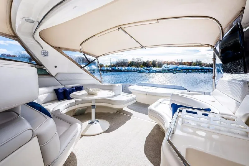 Slide: The Image of Luxurious 1996 Sea Ray 630 Super Sun Sport yacht interior with elegant seating and waterfront view. - 7