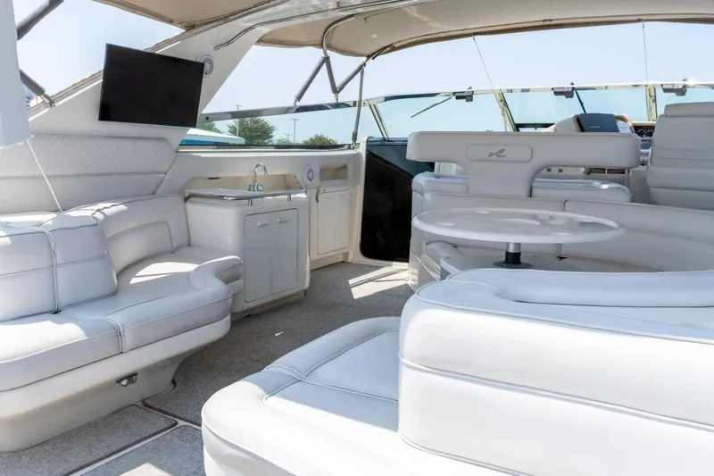 Slide: The Image of Luxurious interior of 1996 Sea Ray 630 Super Sun Sport yacht with white seating and amenities. - 9