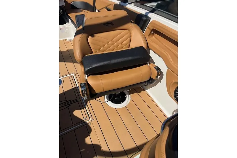 Slide: The Image of 2021 Chaparral 307 SSX boat seat with tan upholstery and black accents. - 12