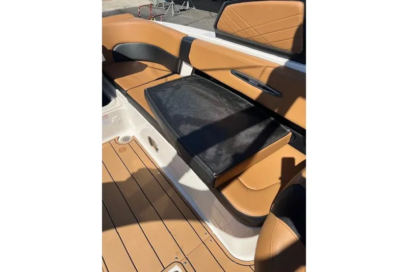 Slide: The Image of 2021 Chaparral 307 SSX boat interior with tan leather seating and black cushion. - 13