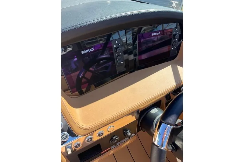 Slide: The Image of Dashboard of 2021 Chaparral 307 SSX boat with Simrad displays and controls. - 14