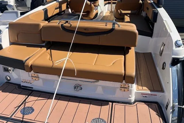 Slide: The Image of 2021 Chaparral 307 SSX boat with tan leather seating and teak flooring. - 2