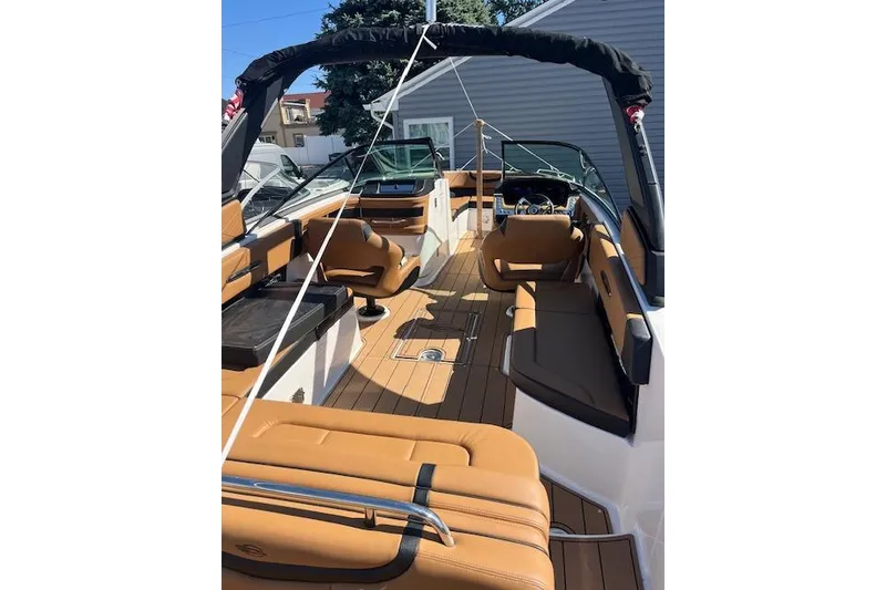 Slide: The Image of 2021 Chaparral 307 SSX boat interior with tan seating and sleek design. - 3