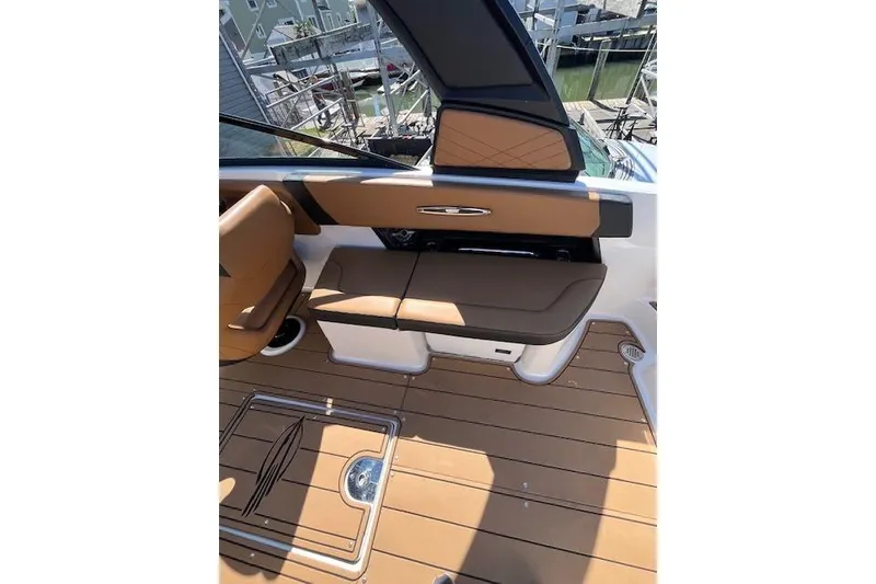 Slide: The Image of 2021 Chaparral 307 SSX boat interior with tan seating and teak flooring. - 6