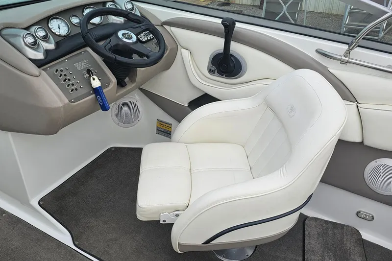 Slide: The Image of 2003 Cobalt 220 boat interior with white captain's chair and control panel. - 10